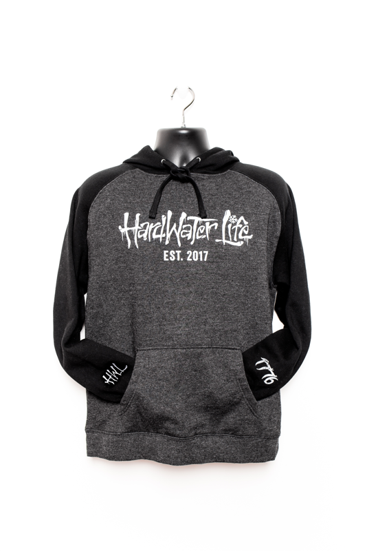 Black and grey hoodie. Cotton/Polyester blend fleece. HardWater Life and Est. 2017 printed in white ink on front of chest. 1776 logo printed in grey scaled on right cuff. The letters HWL printed in grey on left cuff.
